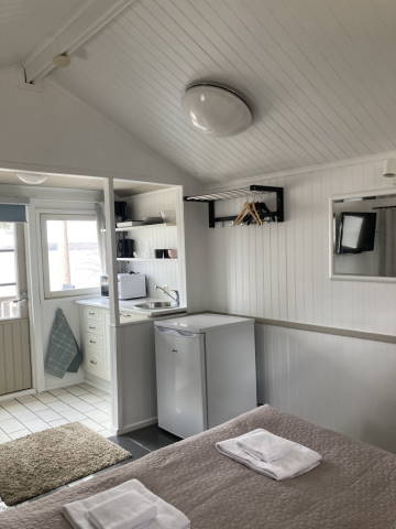 Small cabin after makeover, kitchenette with new shelving and more coheisive look